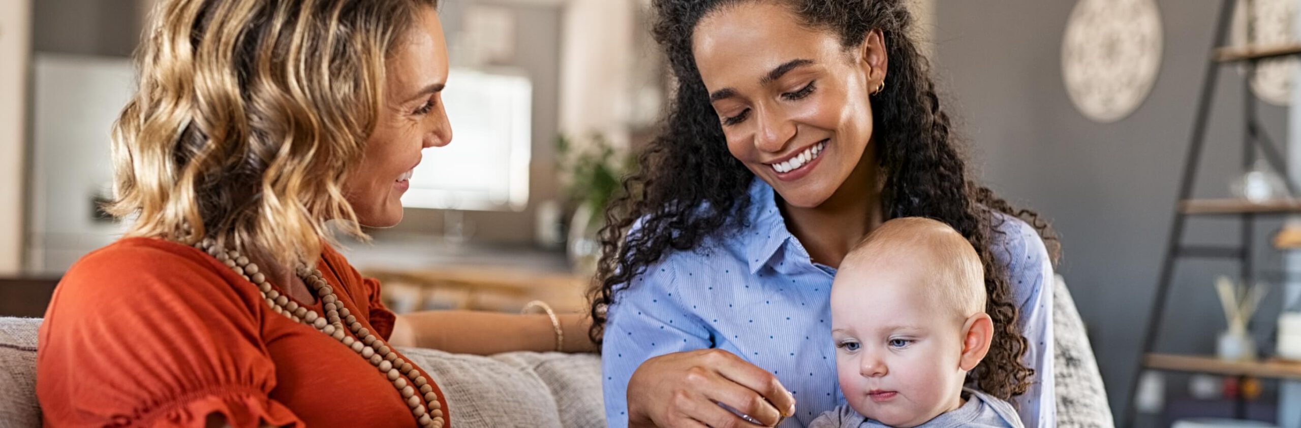 happy-women-friends-playing-with-child-2023-11-27-05-23-31-utc (1)