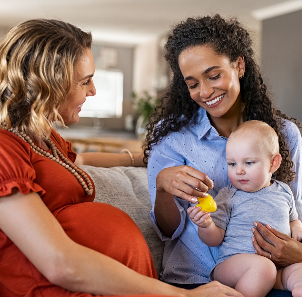 happy-women-friends-playing-with-child-2023-11-27-05-23-31-utc