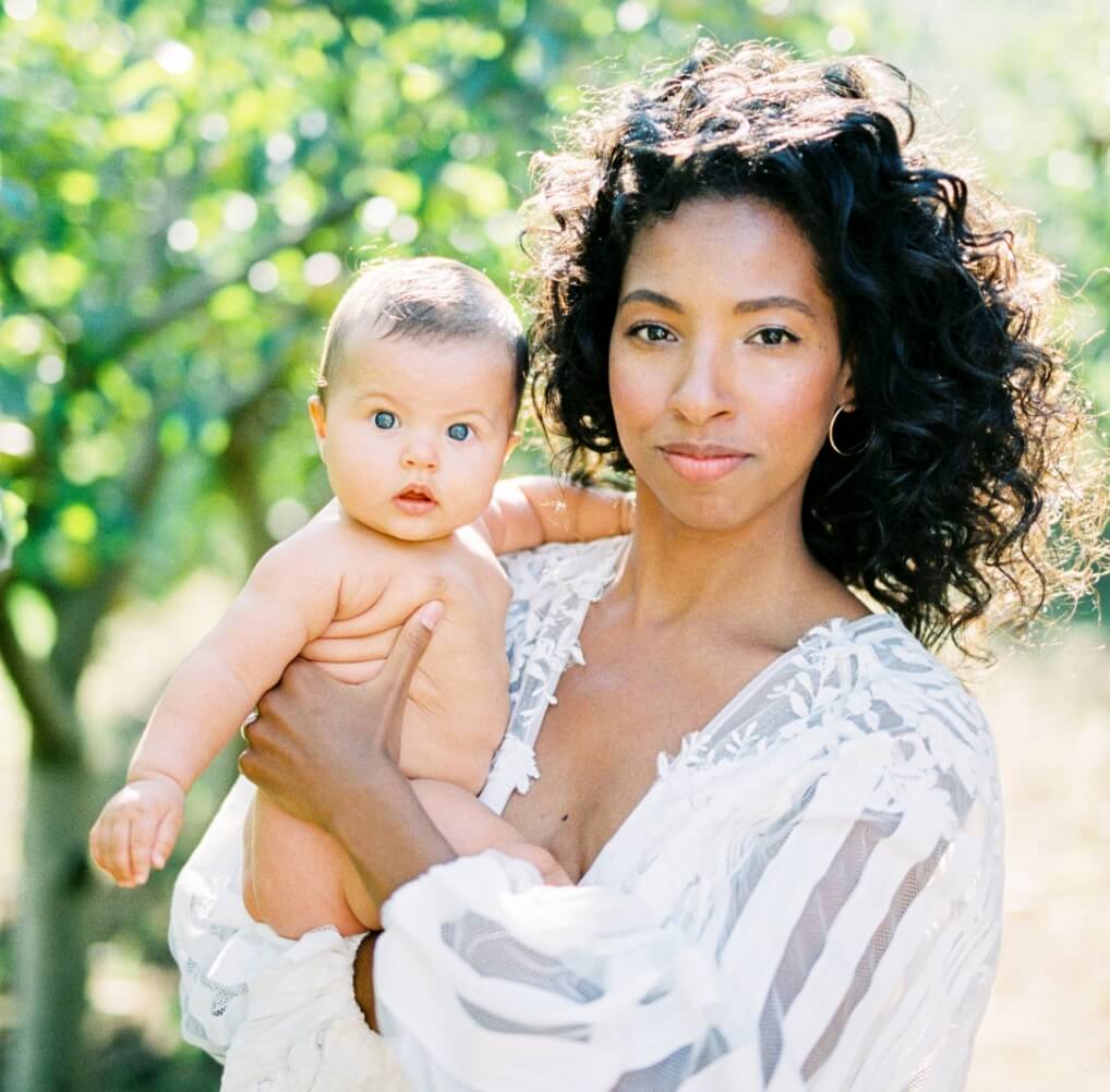 woman-with-a-baby-in-her-arms-in-a-green-garden-2023-11-27-04-55-35-utc (1)